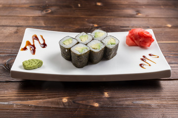 Japanese cuisine. Sushi roll with avocado on white background