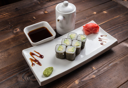 Japanese cuisine. Sushi roll with avocado on white background