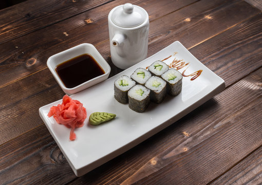Japanese cuisine. Sushi roll with avocado on white background