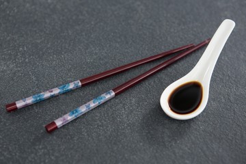Chopsticks and soy sauce on stone table