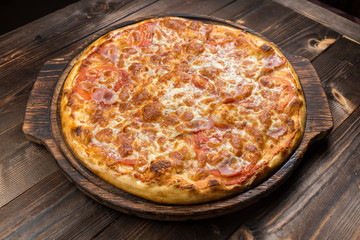 Pizza with Ham and Salami. Garnished with Olives