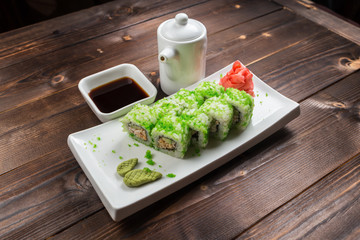 healthy kale and avocado sushi roll with chopsticks