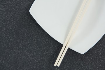 Chopsticks on white plate