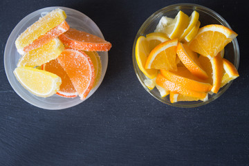 Slices of marmalade. lemon and orange pieces in plate. Yellow and orange.