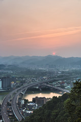 New Taipei City - April 29, 2016 : Lion's Head Mountain Shooting, aerial view of taipei at sunset with highway, cityscape - Asia