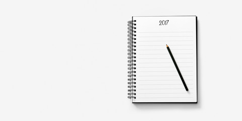 Open notebook on white background with a pencil