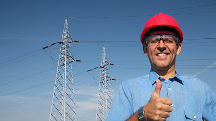 Smiling Worker Near Electrical Transmission Towers