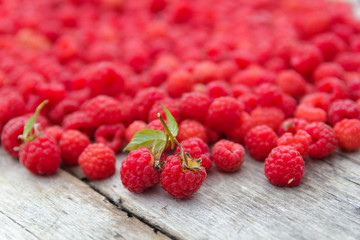 Ripe raspberry on a background of aged wood. Selective focus.