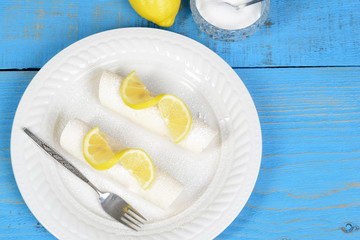 top view lemon crepes with icing sugar