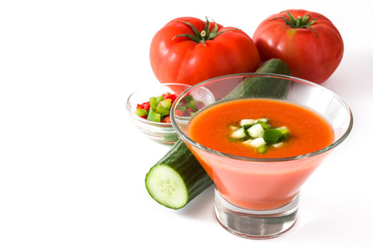 Traditional Spanish cold gazpacho and ingredients soup isolated on white background
