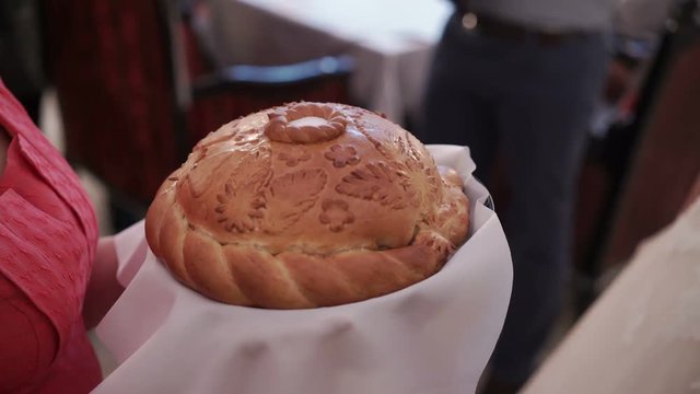 Traditional wedding bread and salt in mother's hands