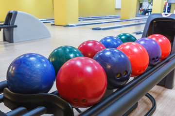 Bowling balls return machine, alley background