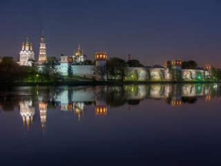Fototapeta na wymiar Moscow monastery Novodevichy Convent at night, with reflection in the pond