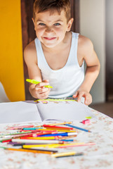 Schoolboy, homework and makes funny face