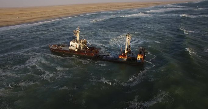 4K aerial drone video view of Namibian Atlantic coastline, Zeila L-758  Walvis Bay shipwreck and sand beach, Skeleton Coast Park landscape with ocean background at Namibia's west coast