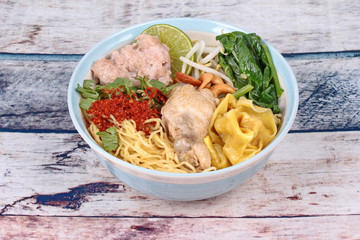 Boiled noodle and wonton in spicy sour soup.
