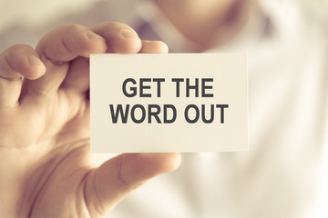 Businessman holding GET THE WORD OUT message card