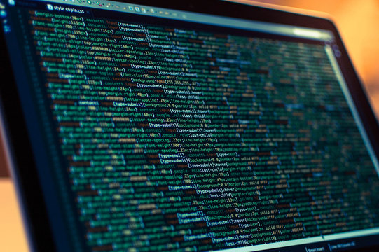 Software development. Software source code. Programming code. Writing programming code on laptop.