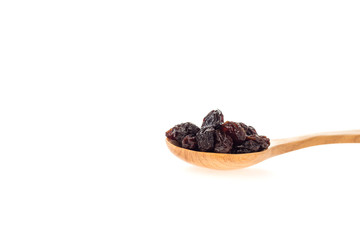 Dried raisins in wooden spoon on white background.