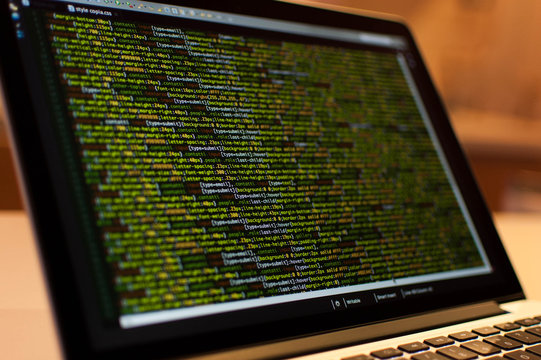 Software development. Software source code. Programming code. Writing programming code on laptop.