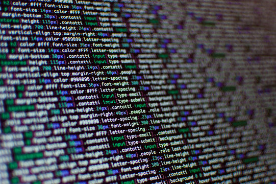 Software development. Software source code. Programming code. Writing programming code on laptop.