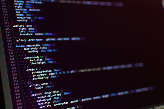 Software development. Software source code. Programming code. Writing programming code on laptop.