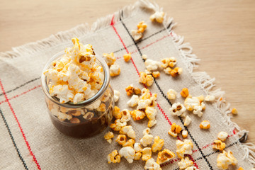 Chocolate dessert with popcorn on wooden table. Homemade cacao tasty pudding.