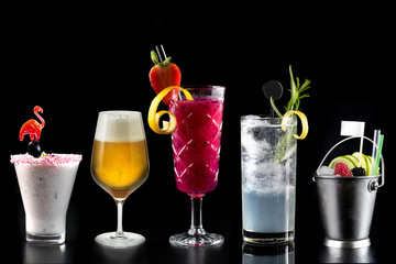 modern rustic selection of cocktails drinks alcohol at bar counter with defocused background various colours glass