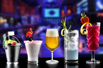 modern rustic selection of cocktails drinks alcohol at bar counter with defocused background various colours glass