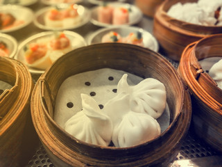 yumcha, dim sum in bamboo steamer with vintage filter