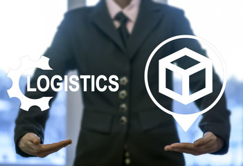 Logistic concept. Man offers in hands icons gear logistics and location cube on virtual screen. Freight management. Global partnership, interaction. Improvement and distribution in business, industry.