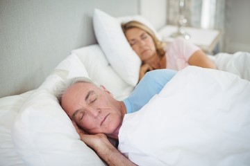 Obraz na płótnie Canvas Senior couple sleeping on bed