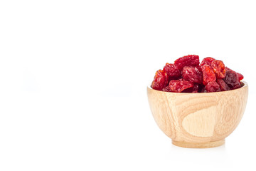 Sun-dried cocktail tomatoes in wooden cup on white background.