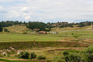 Fototapeta na wymiar A field and homes seen from a trail of Castlewood Canyon State Park