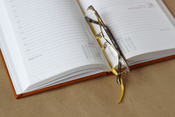 Open diary and glasses
