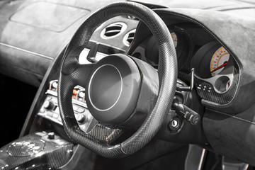 Interior of a modern car, steering wheel and dashboard.