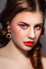Fototapeta premium Vintage style portrait of young beautiful woman with stylish red eyeliner and glossy lipstick