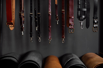 leather straps on the rack near the wall