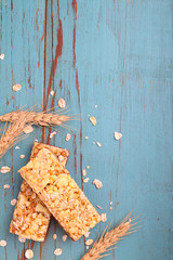 healthy snack, muesli bars with raisins and nuts on a blue background
