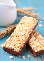 healthy snack, muesli bars with raisins and nuts on a blue background