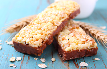 healthy snack, muesli bars with raisins and nuts on a blue background