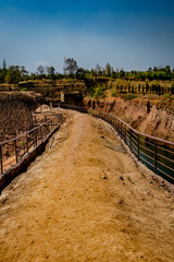 Fototapeta na wymiar Soil pathway with iron railing