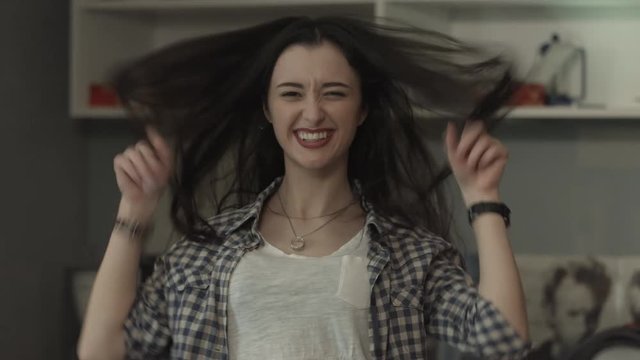 beautiful, cheerful girl hamming and laughs.