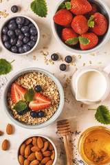 Healthy breakfast - a bowl of oatmeal, berries and fruit, top view.