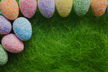 Easter eggs on green background