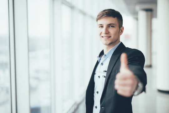 Young Business Man Going Thumb Up At The Office Hall