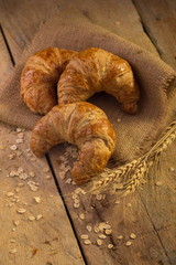 Freshly baked croissants on the dark background.
