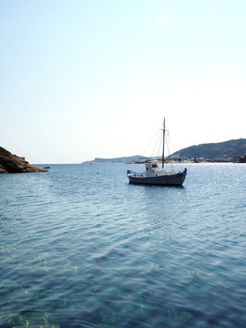 old wood sailboat in Mediterranean Sea Faros harbor on Greek Island of Sifnos