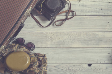 Man's hat and retro accessories for travel on a white painted wo