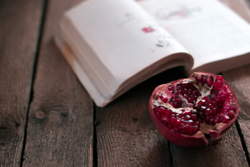 Garnet fruit near the book